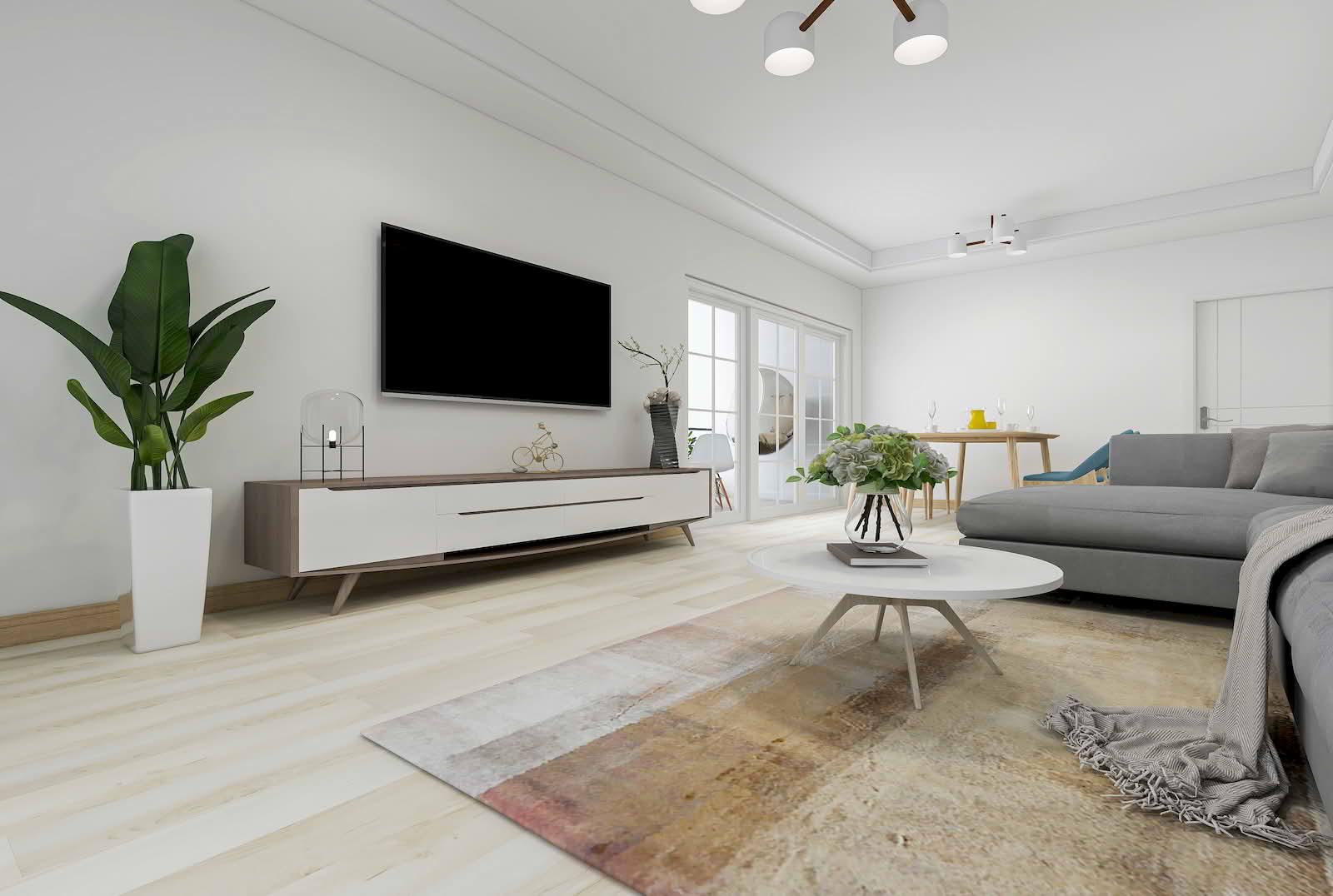 A bright modern living room with light painted walls, a sofa, a TV unit, and natural light coming through glass doors, creating an open and spacious feel.
